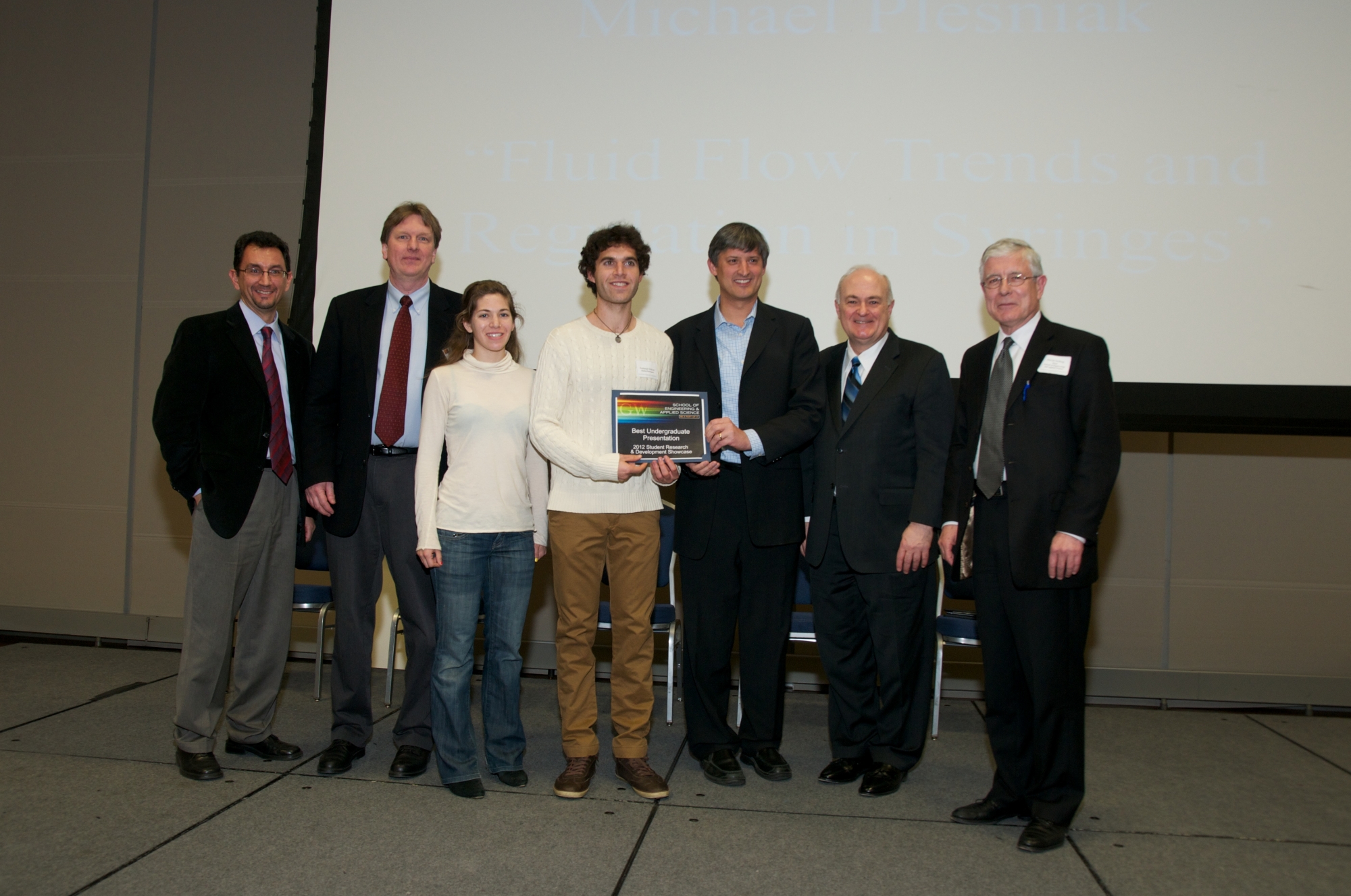 Nathaniel Diskint and Caitlin Keating posing with professors