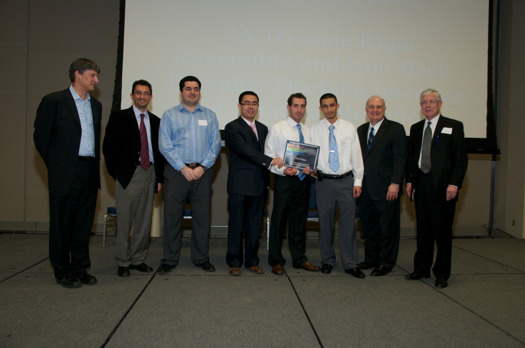Paul Moubarak, Zhou Ma, and Eric Alvarez posing with professors